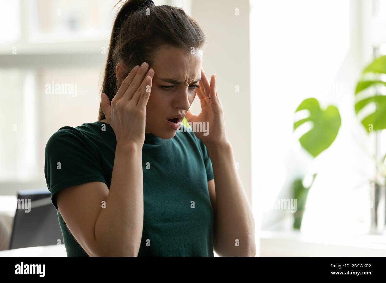 Stressed frustrated millennial woman manager making critical mistake in work Stock Photo