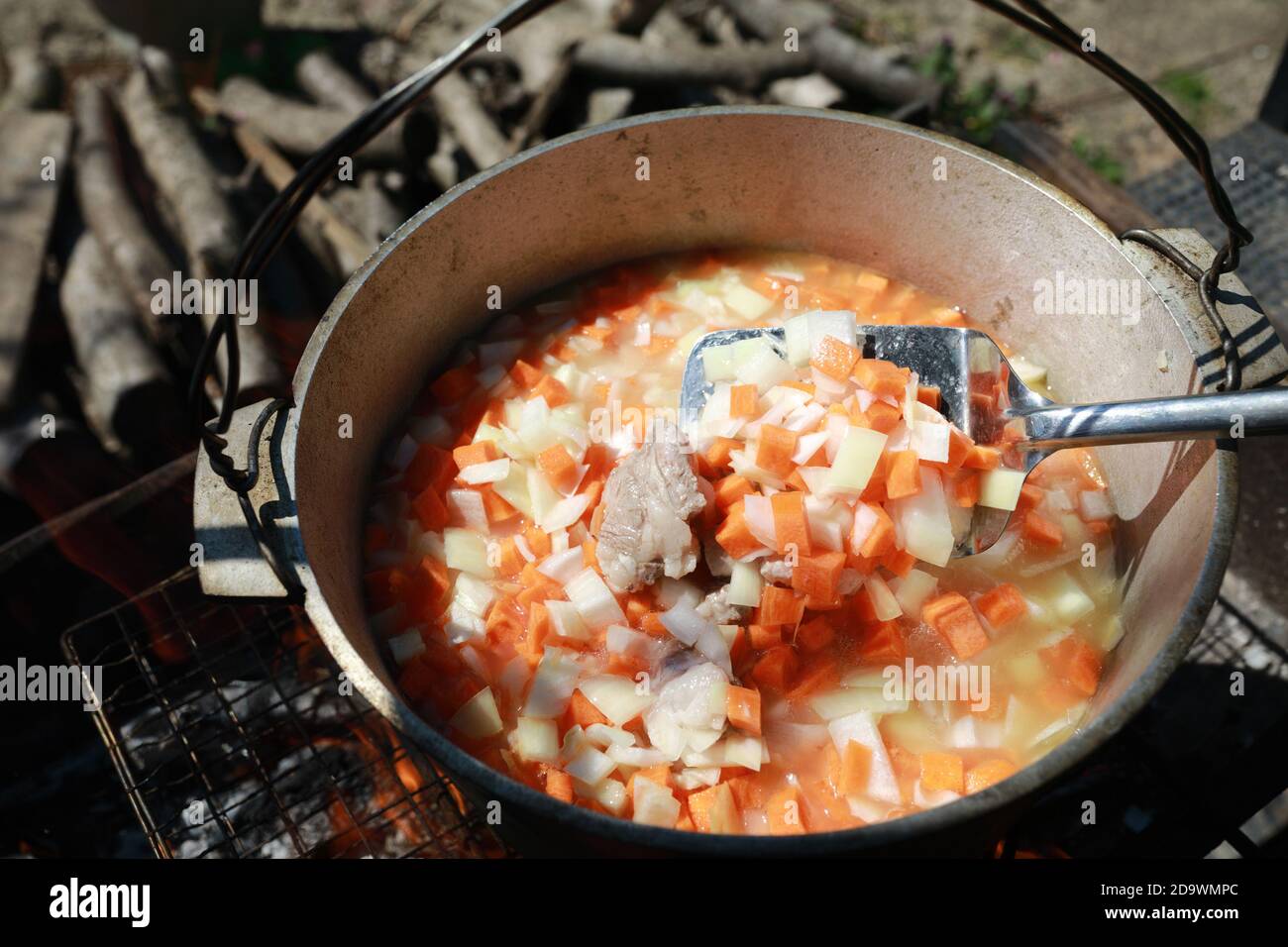 Cooking zirvak for pilaf in cauldron on coals Stock Photo