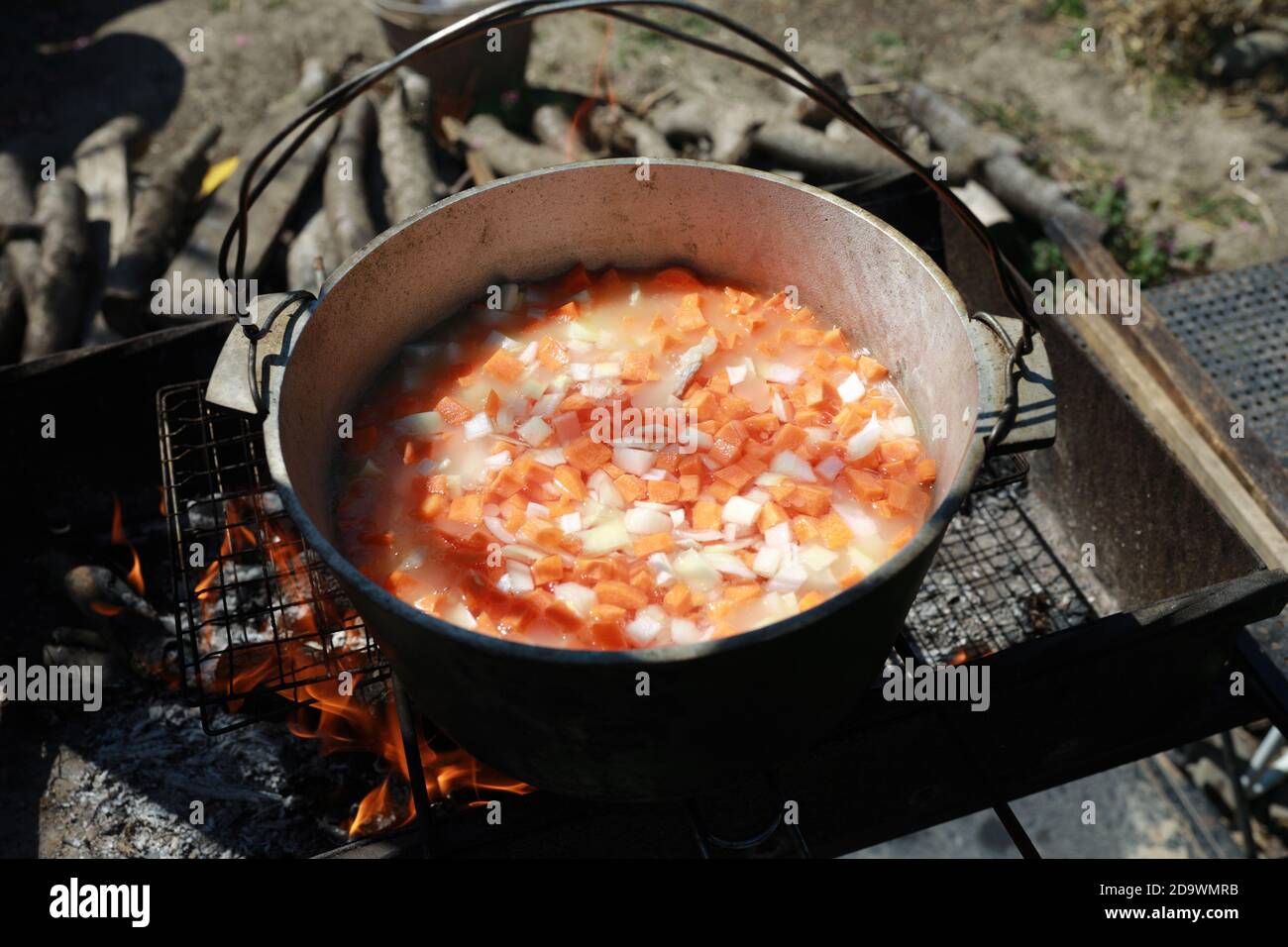 Cooking of zirvak for pilaf in cauldron on coals Stock Photo