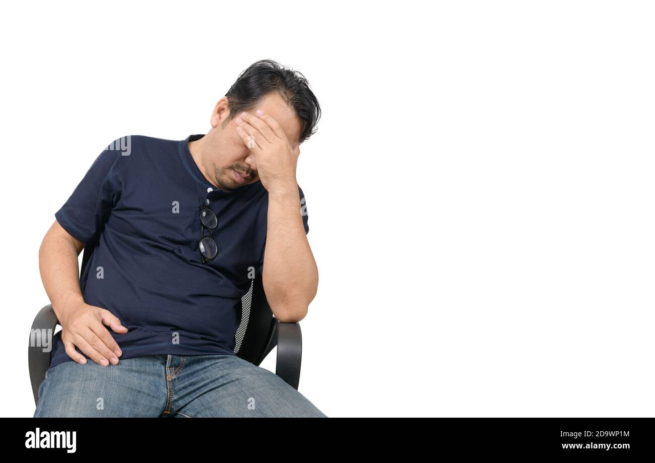 Middle-aged man sitting on chair and feeling stressed and headache isolated on white background. Problem and health care concept. Stock Photo