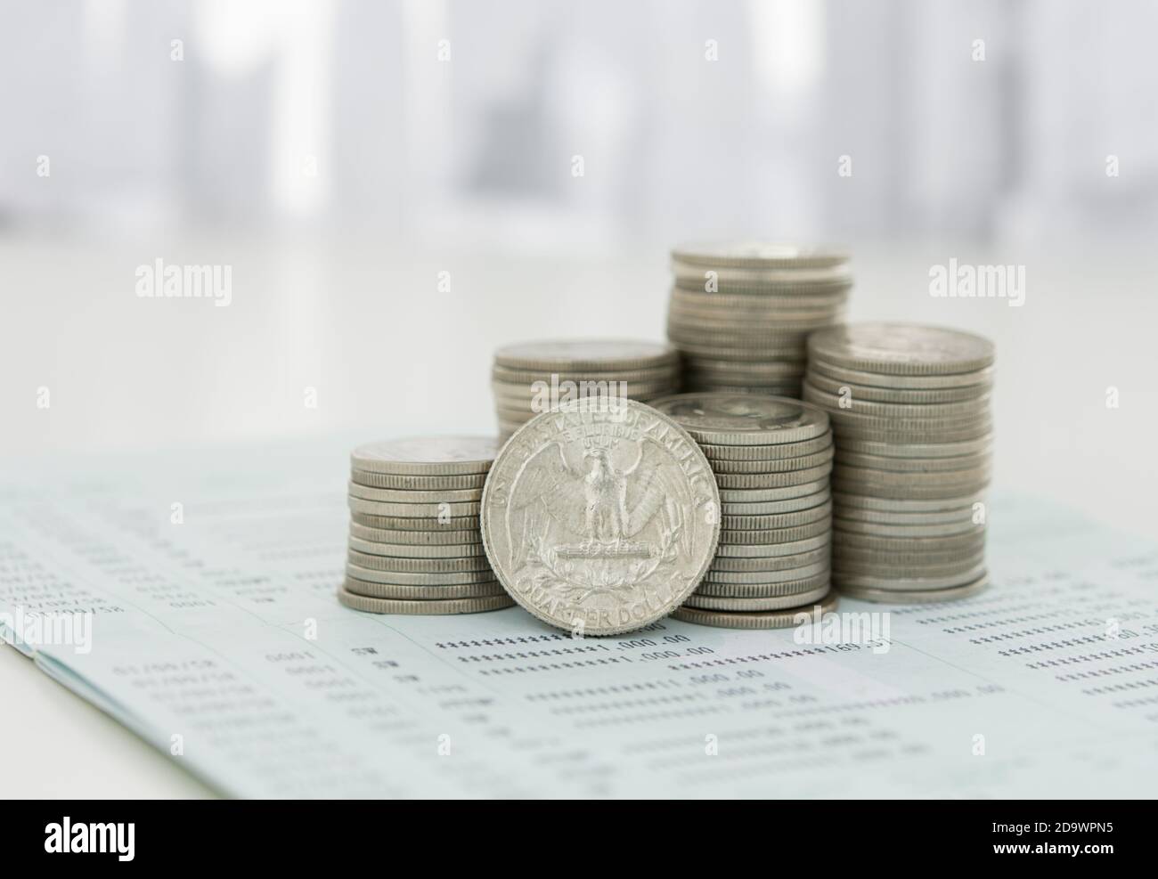 Coin stack on bank passbook with city in background. Savings, Finance and Banking, Investing, Business Investment Growth Concept. Stock Photo