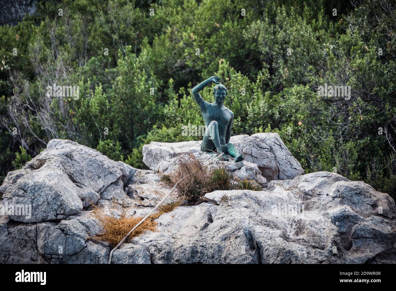 Capri, Italy - August 27 2020: Gennarino Scugnizzo Statue of a Young Boy Greeting the Visitors on a Rock Stock Photo