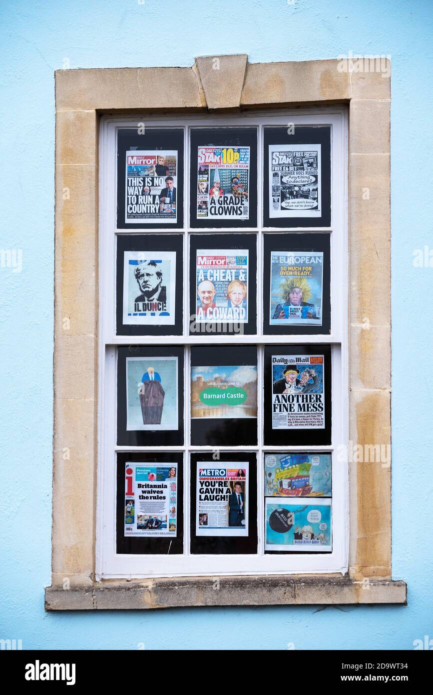 Bristol, Redcliffe. Residential house sash window displaying newspaper front pages and prints critical of the Boris Johnson UK Tory Government. Stock Photo