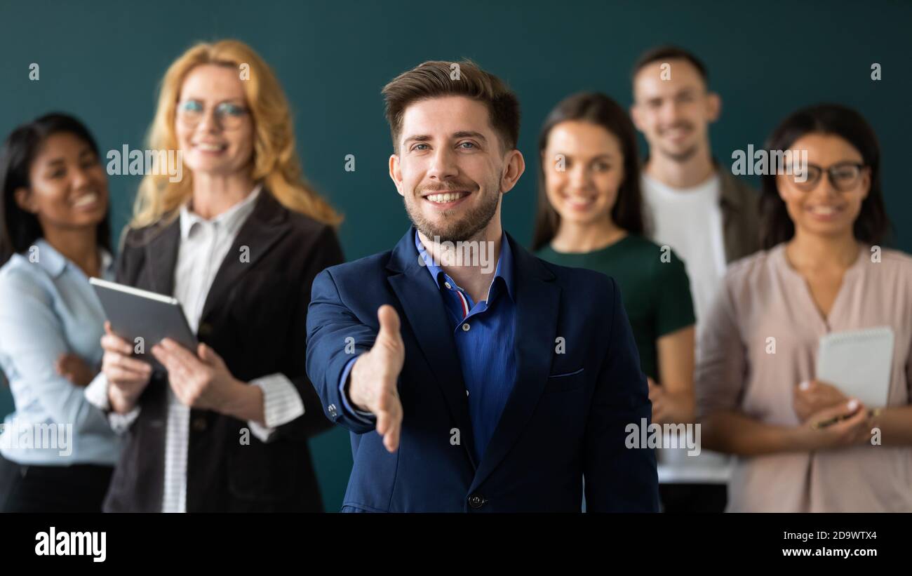 Positive confident male hr extending hand greeting new staff member Stock Photo