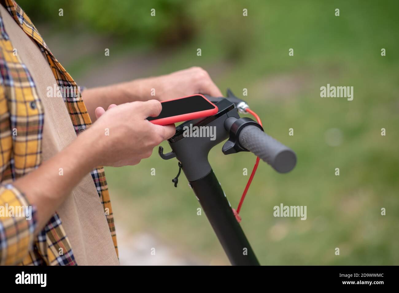 Connection. Man holding a telephone and connecting with scooter