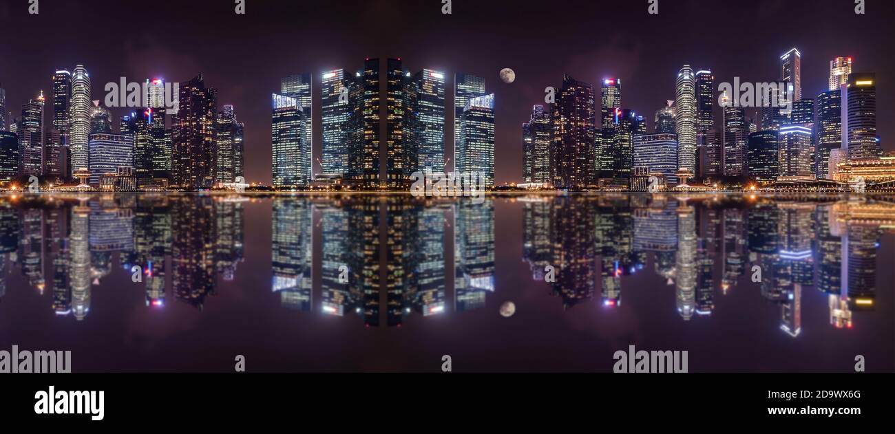 Panoramic view at night of  a megalopolis skyscrapers  with reflection  of Singapore city. Stock Photo