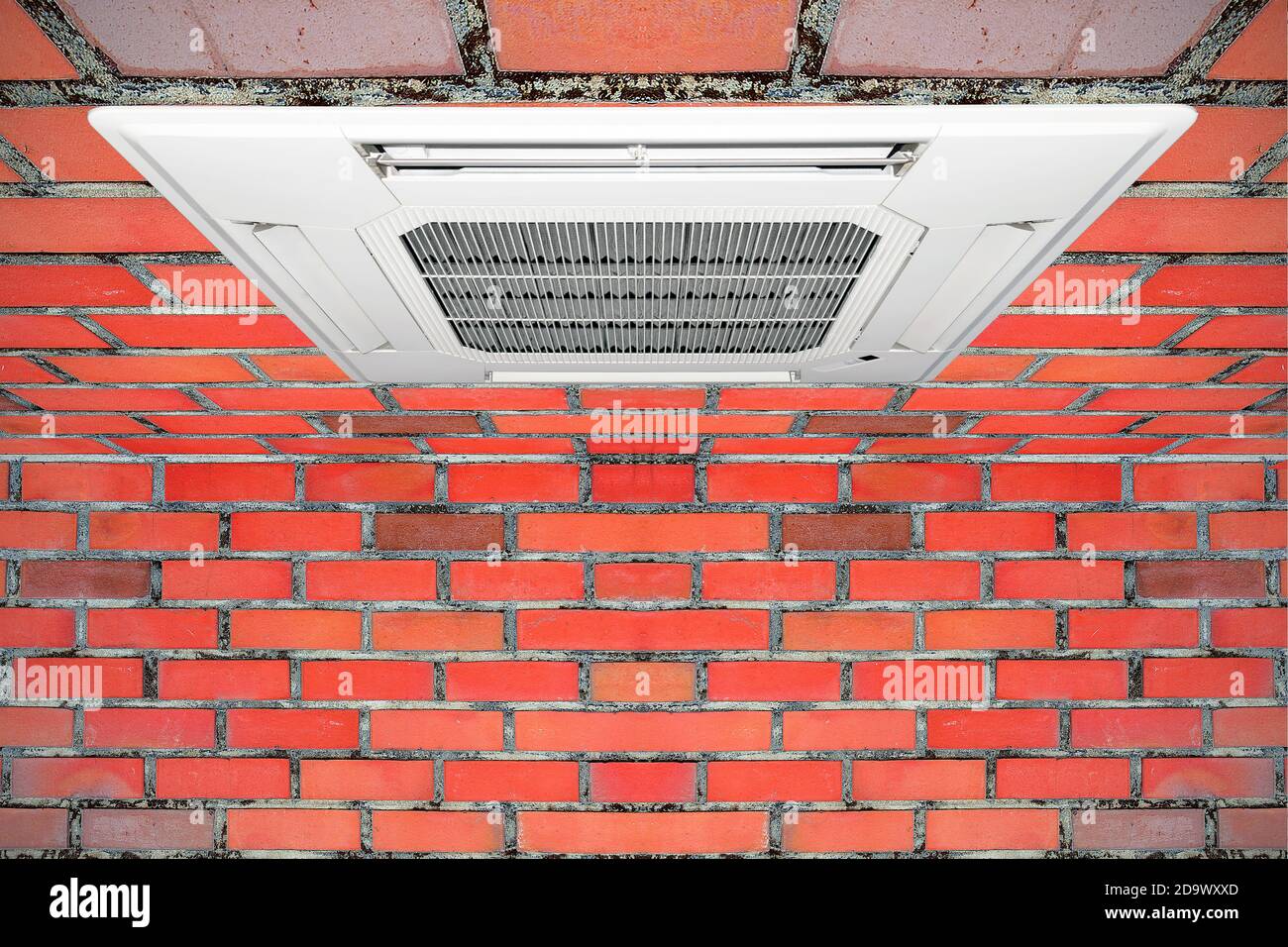 Built-in air conditioner for home and office embedded on the ceiling made of red brick. Stock Photo