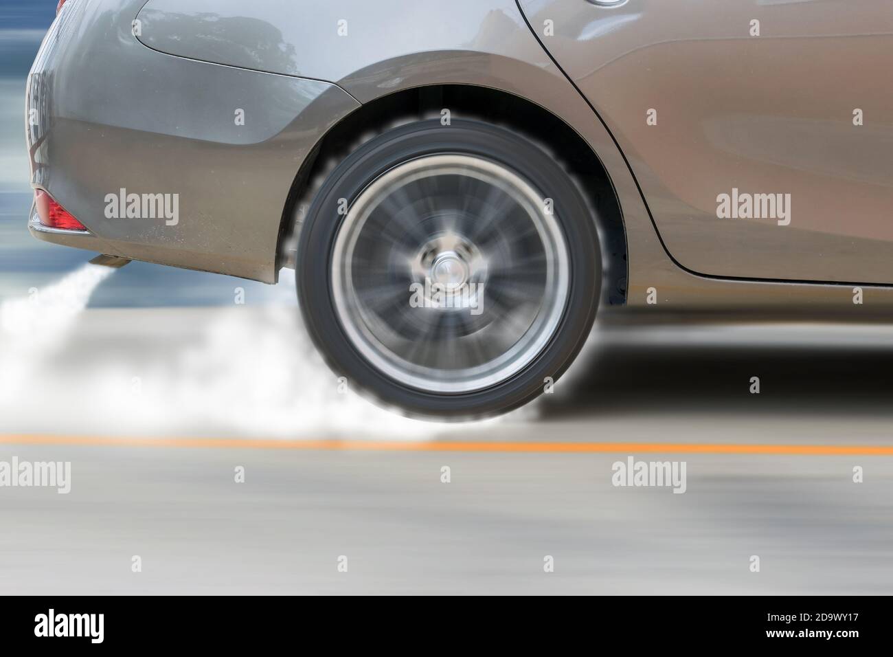 The show car was drifting on the racetrack and cause smoke from the exhaust and tire friction