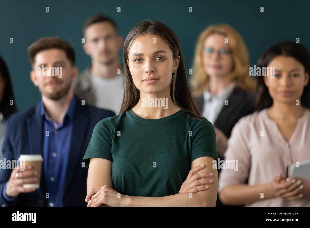 Portrait of millennial woman employee feeling part of corporate team Stock Photo