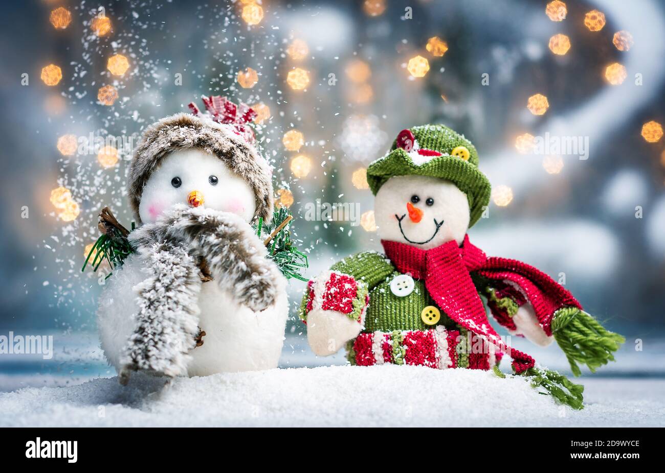 Two snowman with festive illuminated Christmas holiday abstract background Stock Photo
