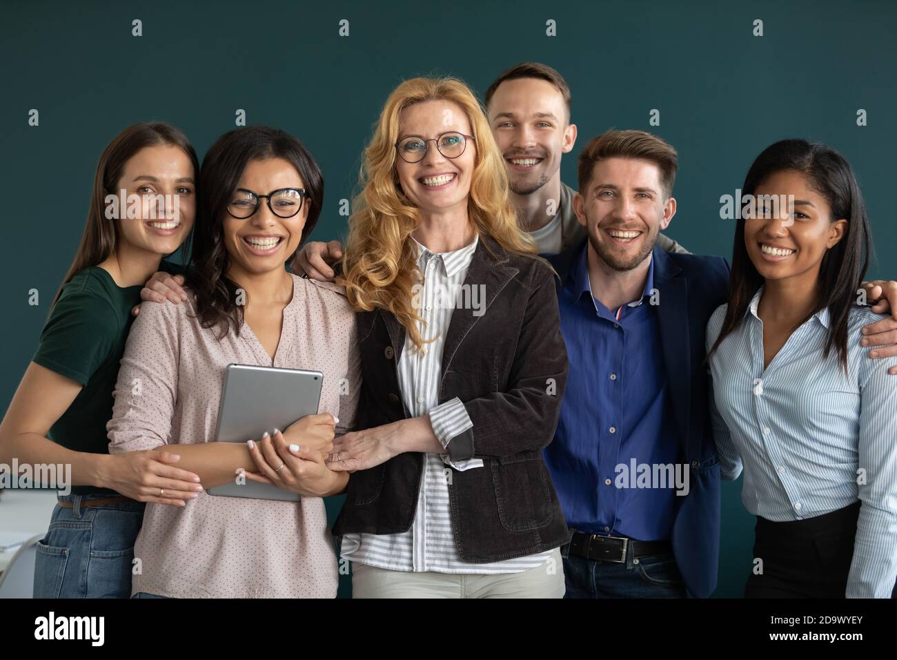 Group portrait of happy ambitious motivated multiethnic team standing together Stock Photo