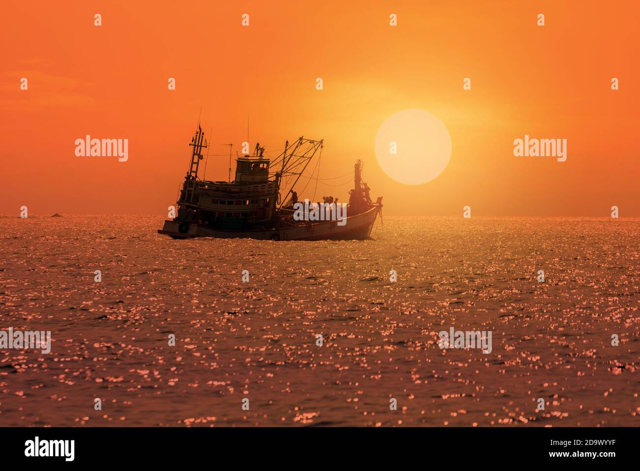 Silhouette of fishing boat in the sea with colorful sunset background ...