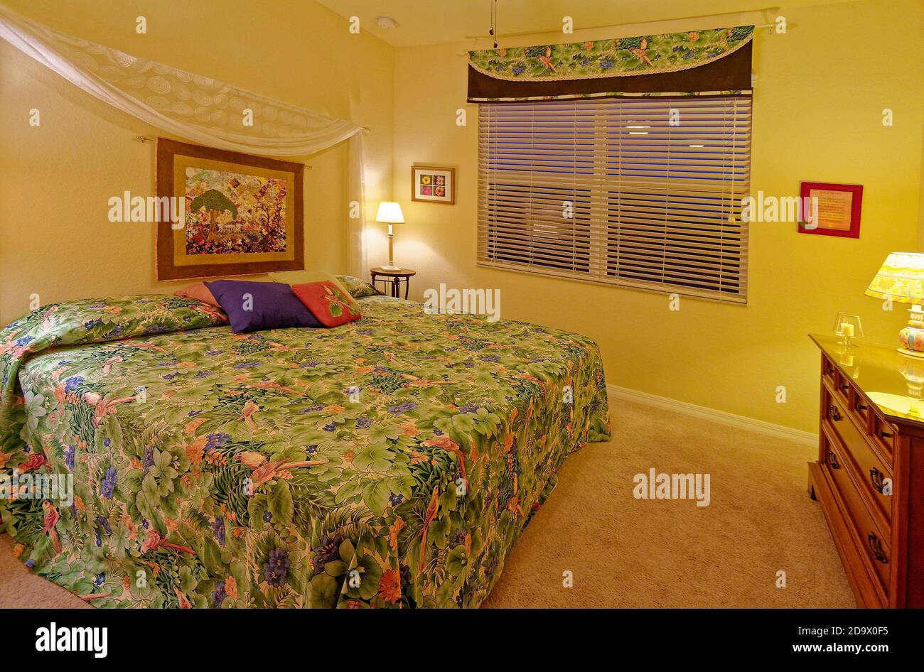 bedroom; king size bed; night tables; lamps; incandescent lighting