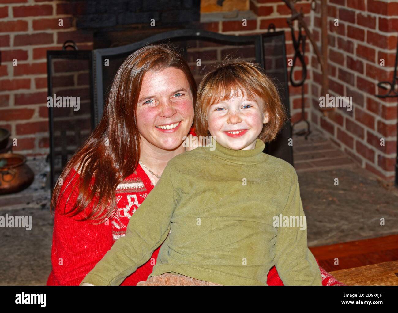 https://c8.alamy.com/comp/2D9X0JH/woman-young-boy-mother-long-lustrous-hair-son-pale-skin-smiling-happy-family-love-fireplace-mr-2D9X0JH.jpg