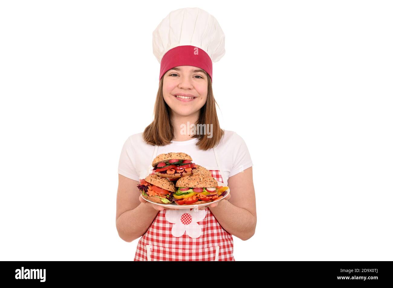 happy female cook is holding plates with vegan sandwiches Stock Photo