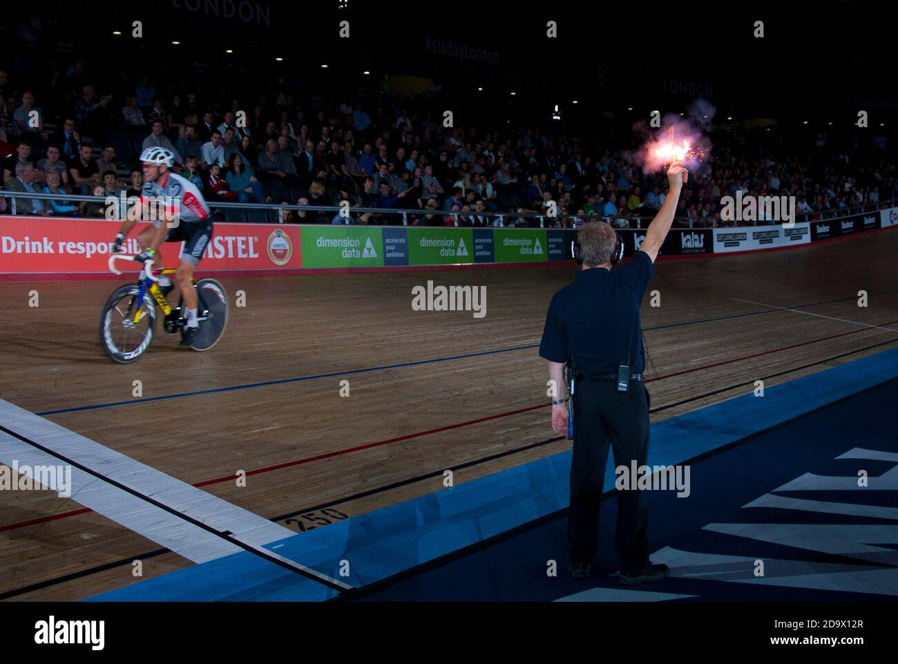 The Commissaire fires the starting pistol. Riders were taking part in the Six Day track cycling championship at Lee Valley Velodrome, London, UK. Stock Photo