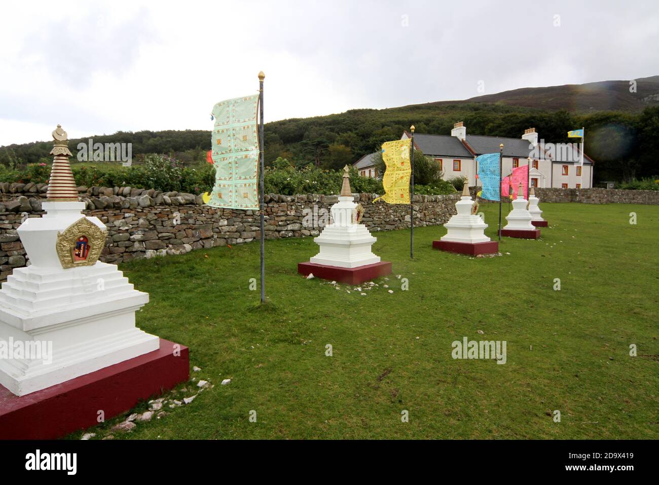 The Centre for World Peace and Health, with Tibetan flags and stupas on Holy Island, Lamlash Bay, Isle of Arran, Ayrshire, Scotland, UK Stock Photo