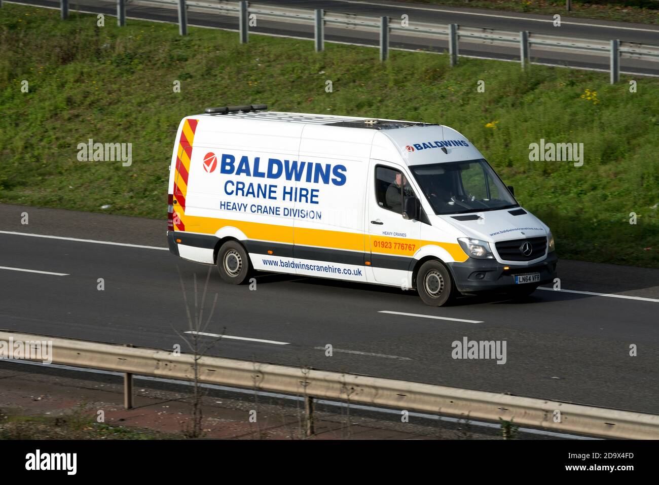 A Baldwins Crane Hire abnormal load escort vehicle, M40 motorway, Warwickshire, UK Stock Photo