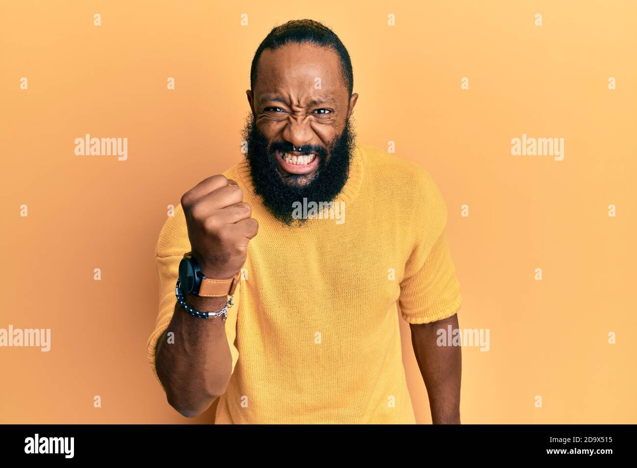 Young african american man wearing casual clothes angry and mad raising ...