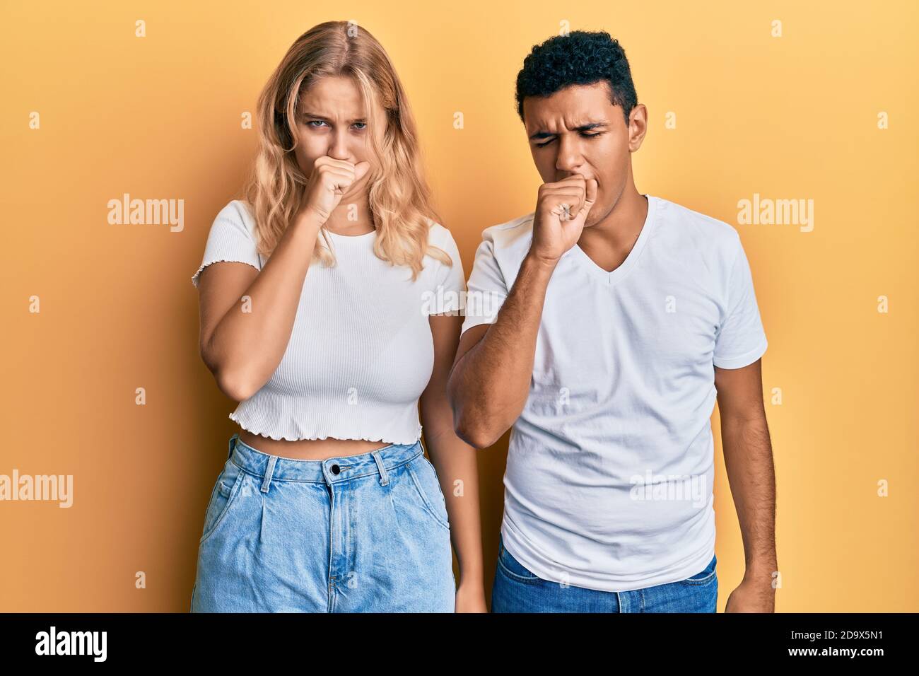 Young interracial couple wearing casual white tshirt feeling unwell and ...
