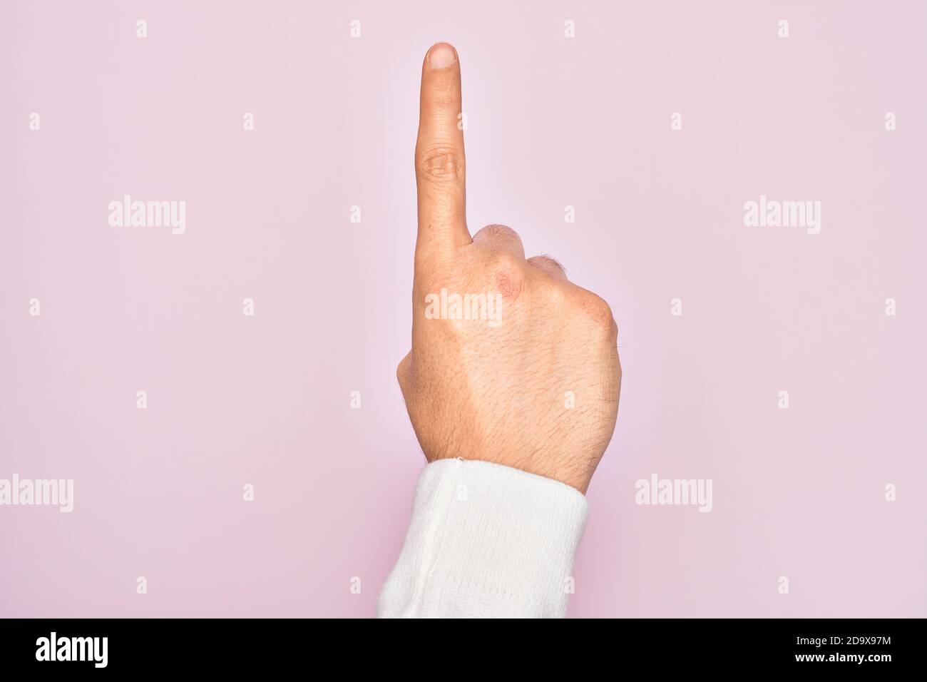 Hand of caucasian young man showing fingers over isolated pink ...