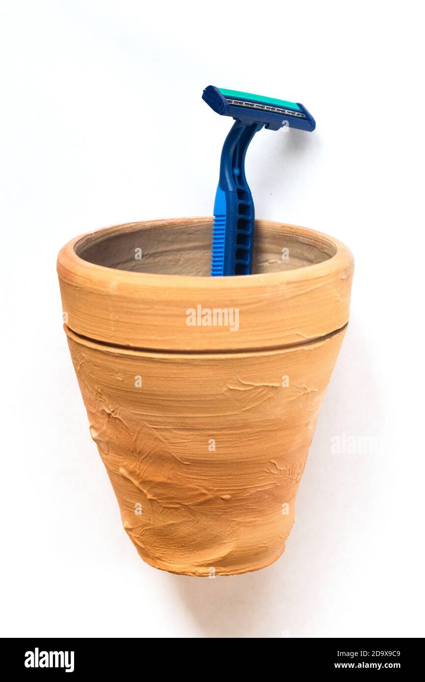 The razor is in a clay mug. White background Stock Photo - Alamy