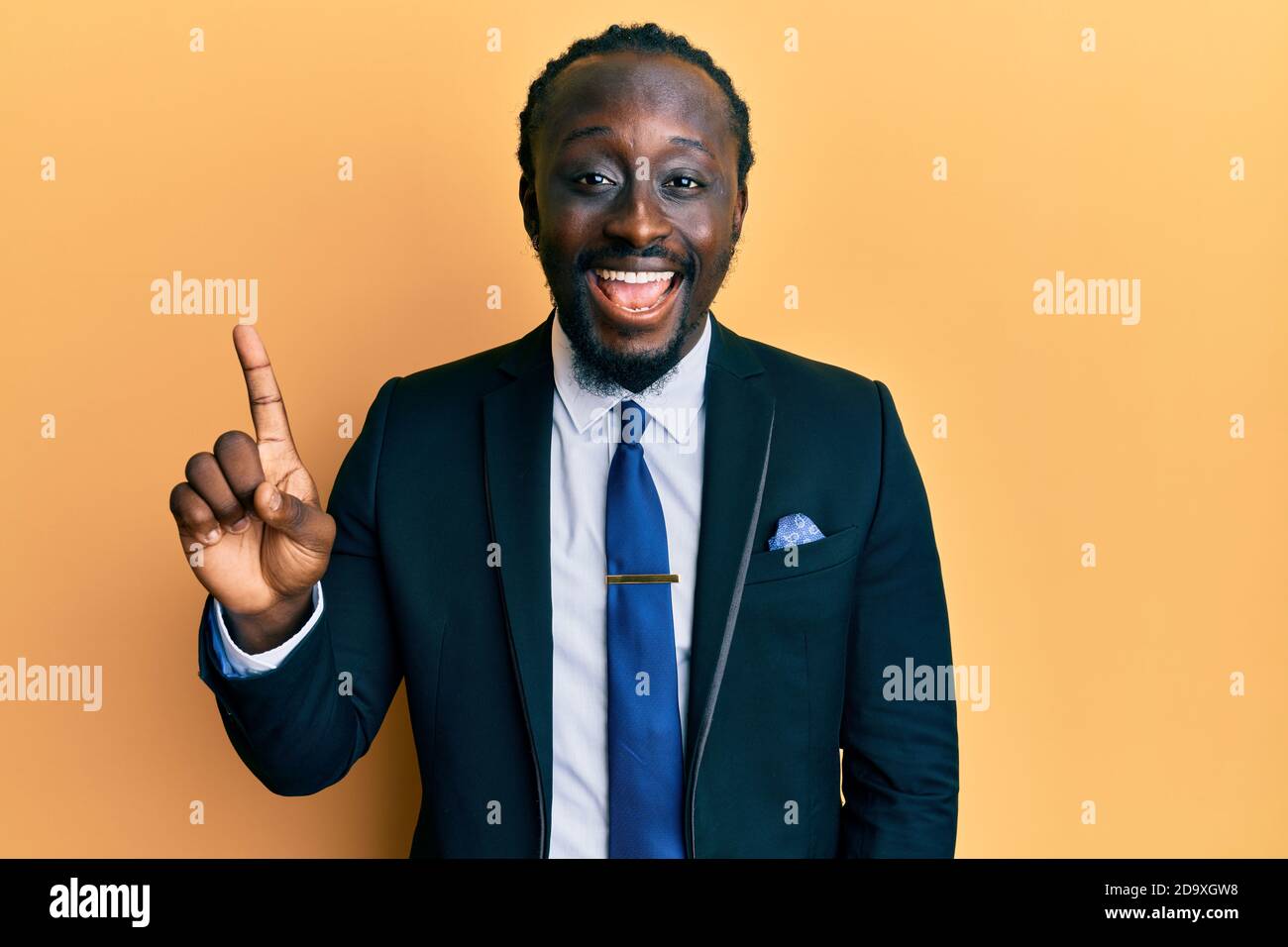Handsome young black man wearing business suit and tie smiling with an ...