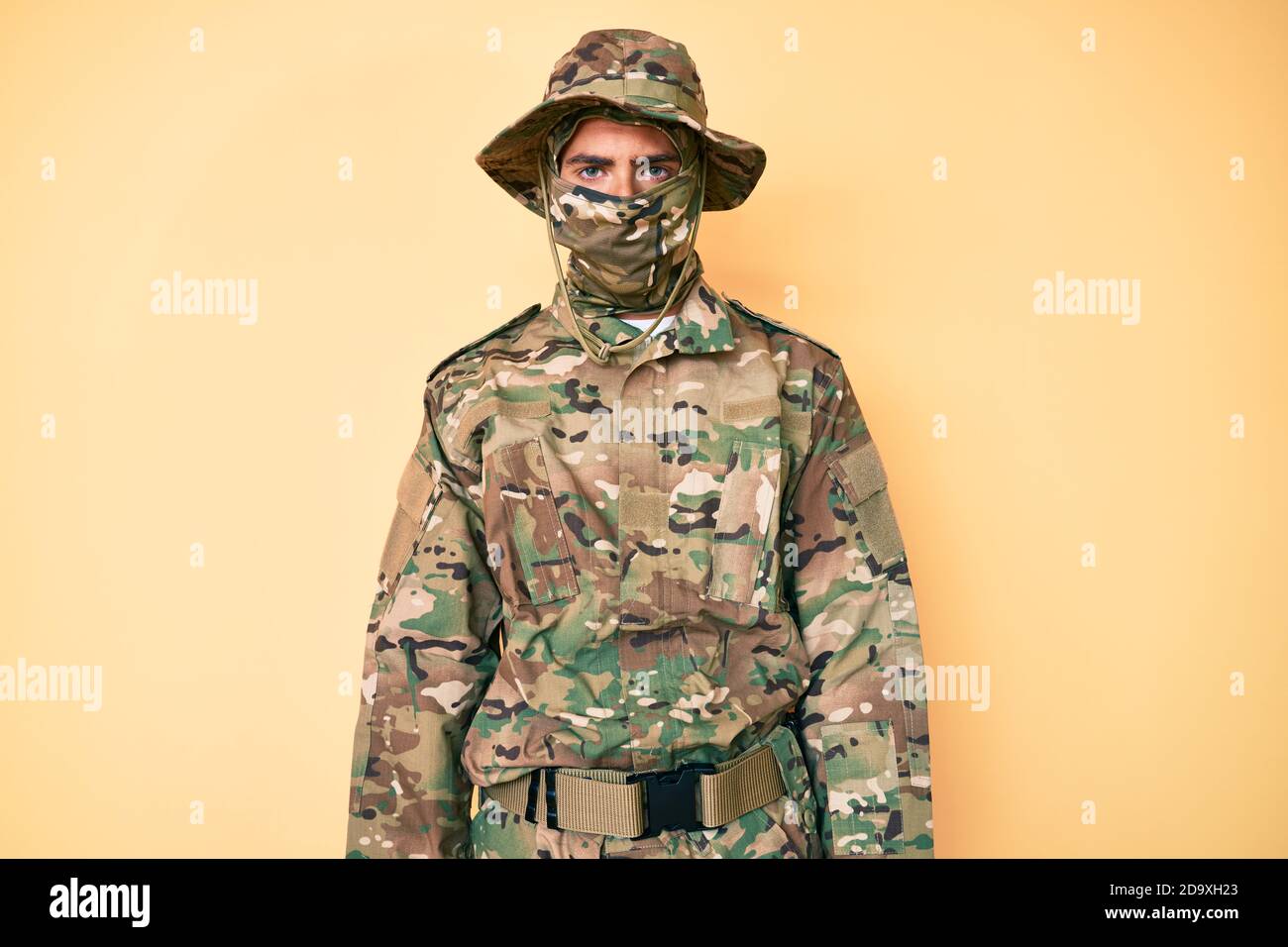 Young handsome man wearing camouflage army uniform and balaclava with ...