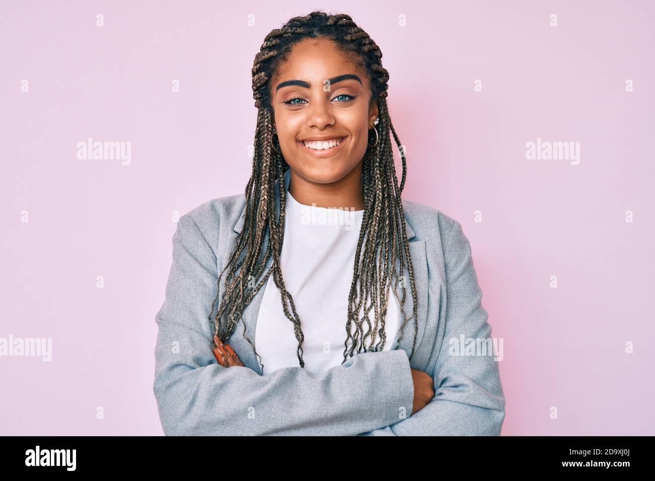 Young african american woman with braids wearing business jacket happy ...