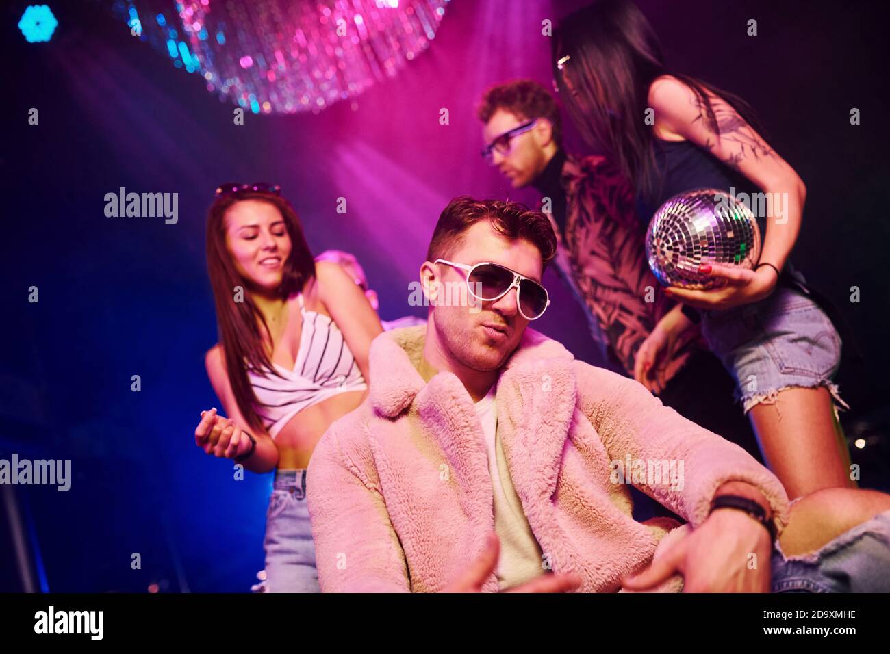 Elegant man in sunglasses in the midle feels like a boss. Young people