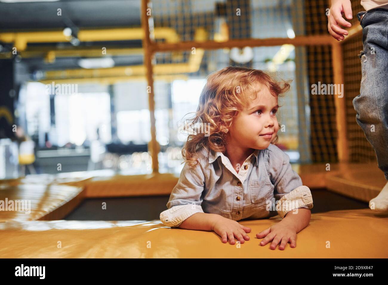 Child sitting in playroom. Kindergarten educational games Stock Photo