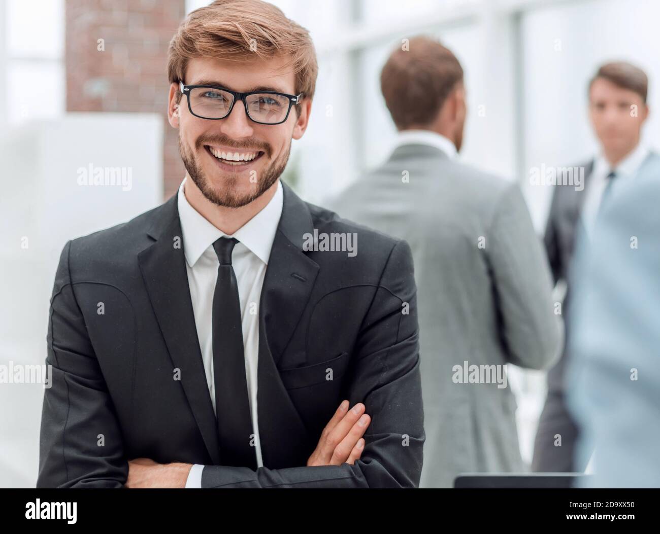 smiling young businessman at the workplace office Stock Photo - Alamy
