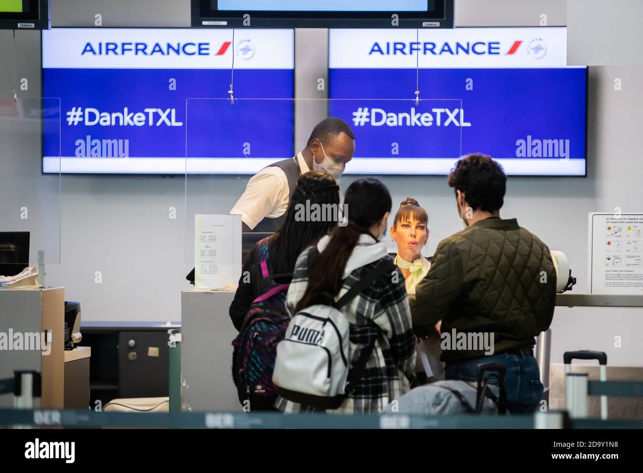Berlin, Germany. 08th Nov, 2020. Passengers stand at the Air France  check-in counter in Terminal C at Tegel Airport to be checked in for the  last scheduled flight from Tegel to Paris.