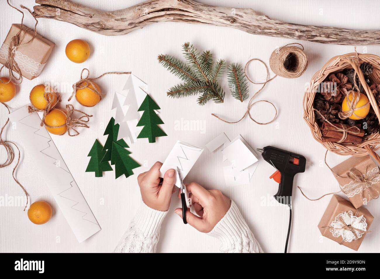 DIY Christmas home decor from natural materials. Hands make ...