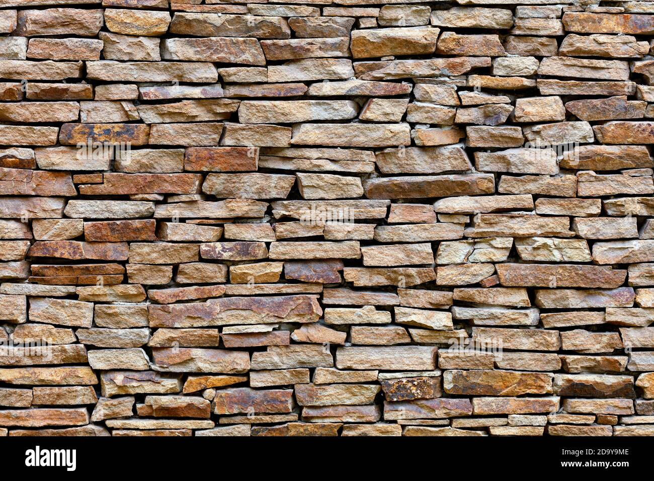 Part of a sandstone stone wall, expressive texture and background in