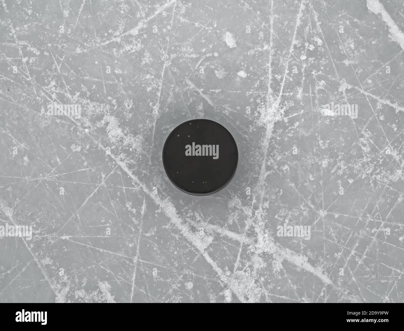 Puck on ice hockey rink surface, hockey background Stock Photo