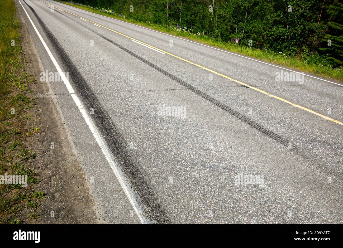 Very long skid marks on tarmac surface at highway after hard braking  at Summer , Finland Stock Photo