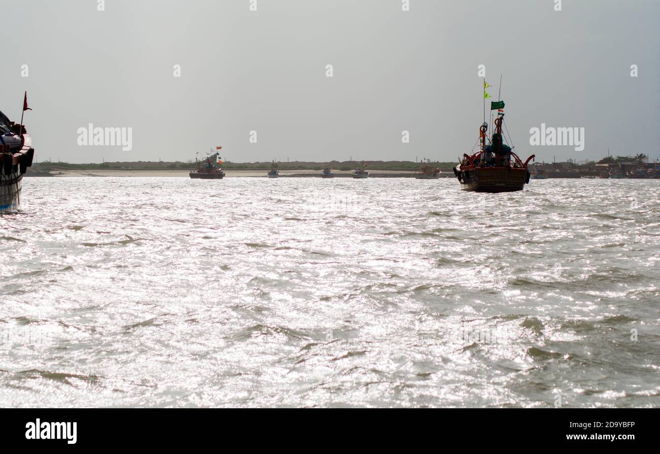 ferry boats sail on the sea from okha to dwarkadhish temple Gujarat India Stock Photo