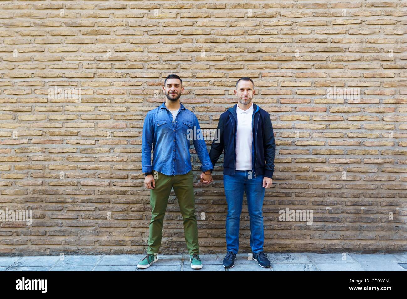 Two gay men holding hands hi-res stock photography and images - Alamy