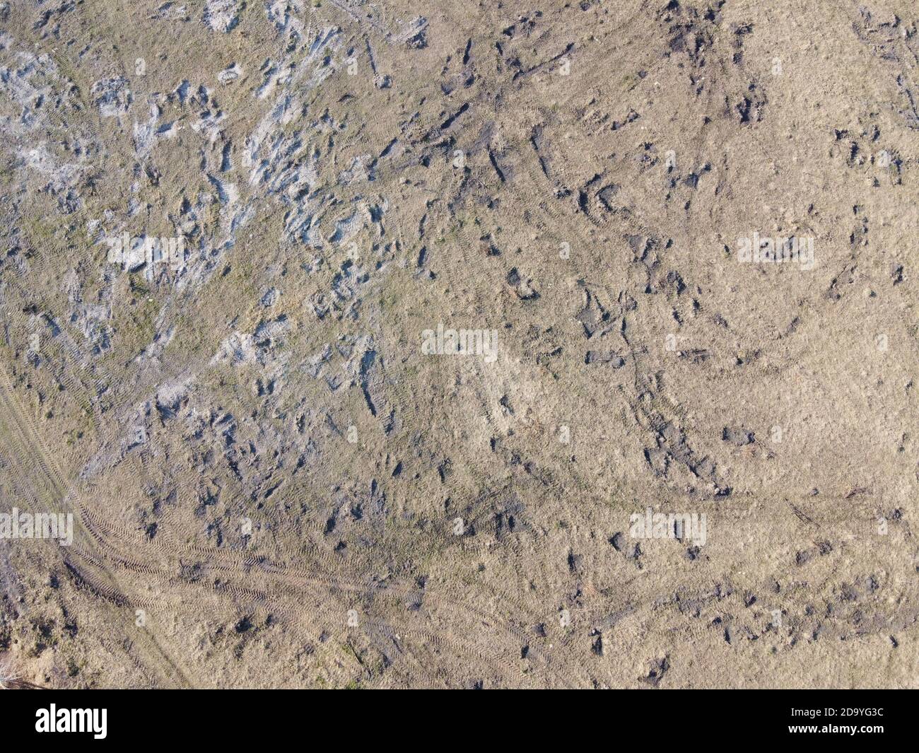 Traces of construction equipment on the soil, aerial view. Lifeless land, wasteland. Stock Photo