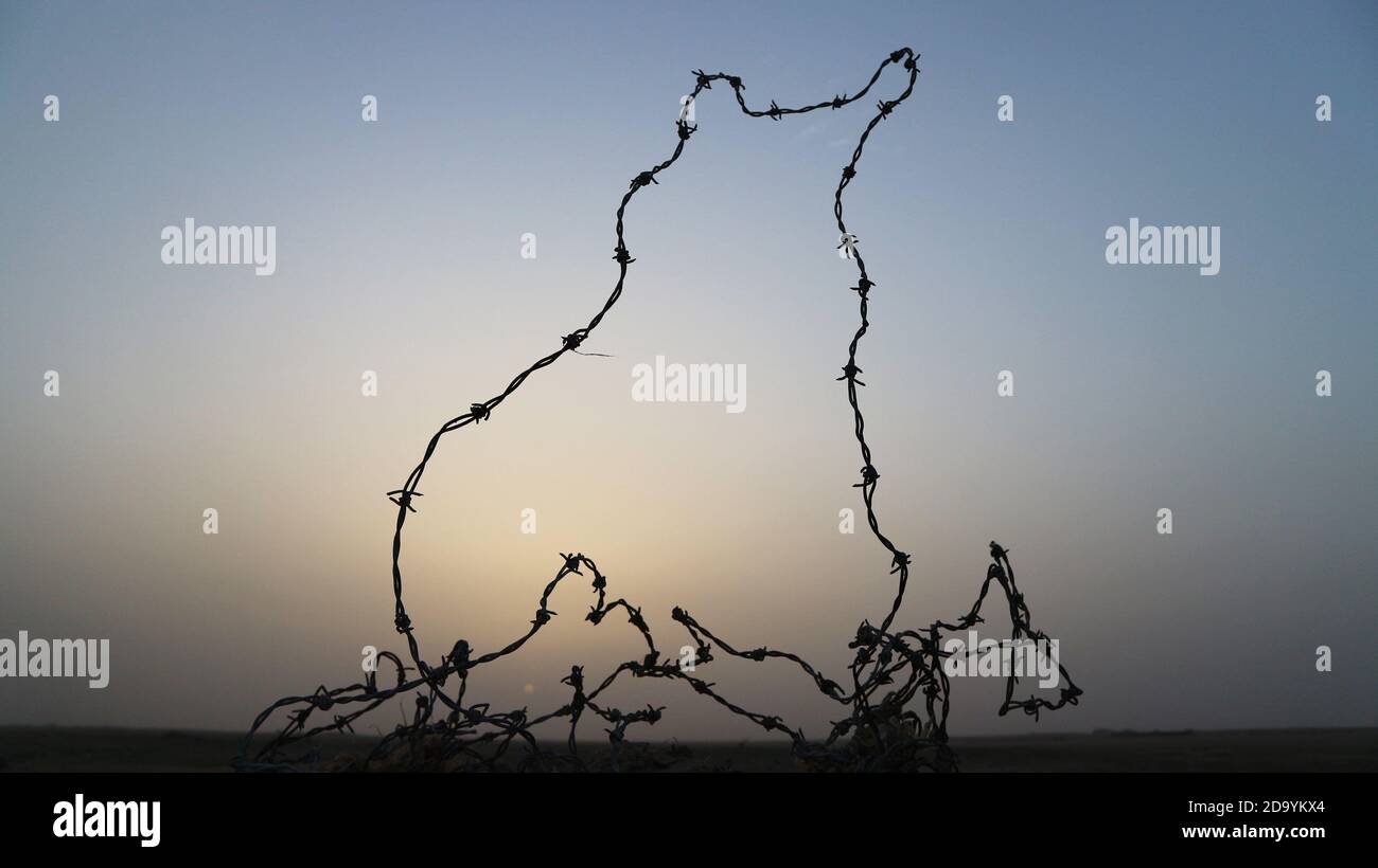 Barbed wire loop with dusk background Stock Photo