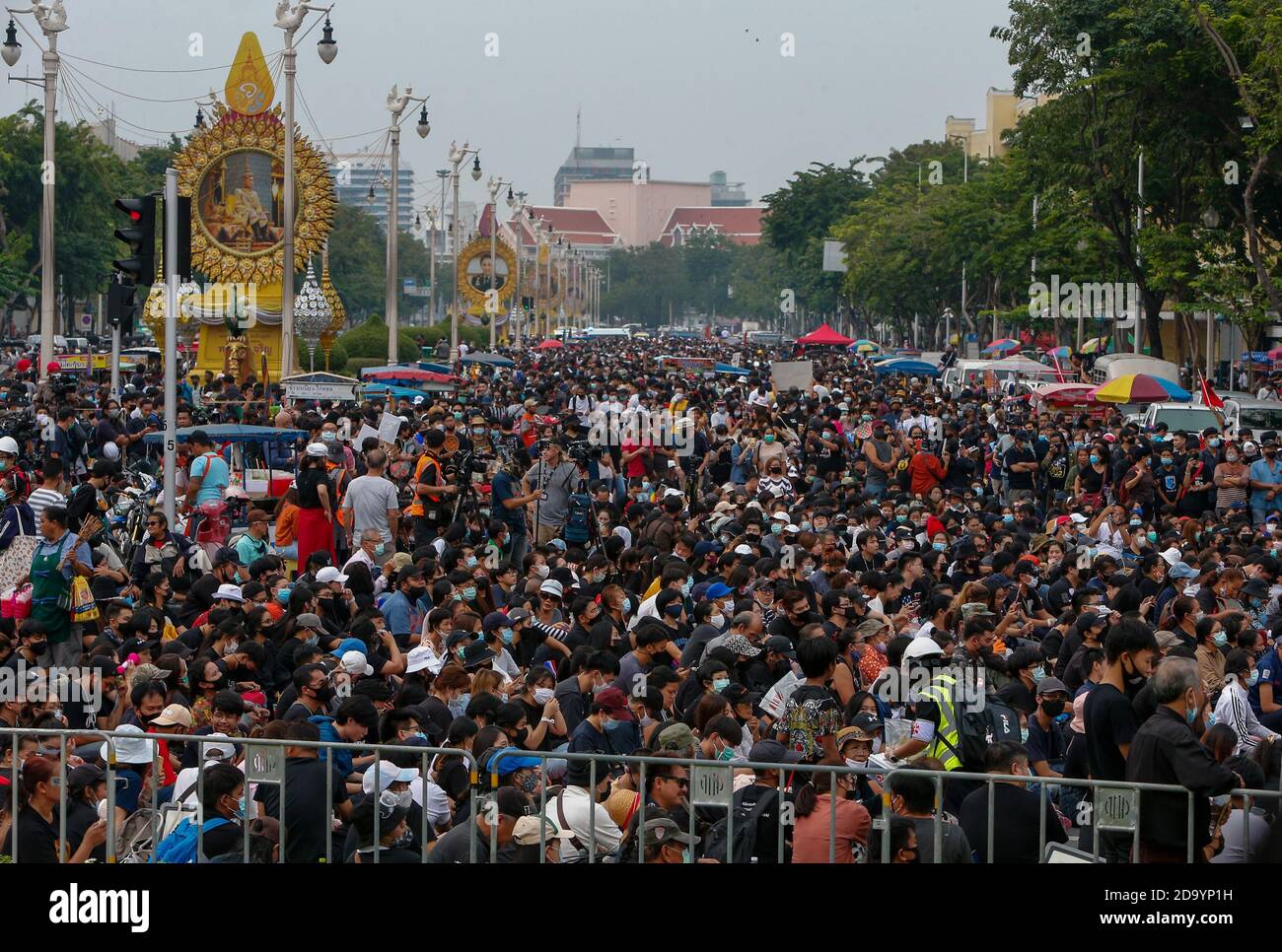 Huge crowd of protesters during the demonstration. Police fired water cannons at pro-democracy protesters to prevent them from marching from the Democracy monument to the Royal Household Bureau at the Grand Palace to submit letters regarding monarchy reform. The letters were placed in giant mail boxes and addressed to the bureau. Stock Photo