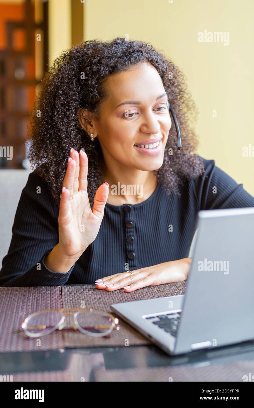 Photo of an African woman with laptop having video call. Close-up ...
