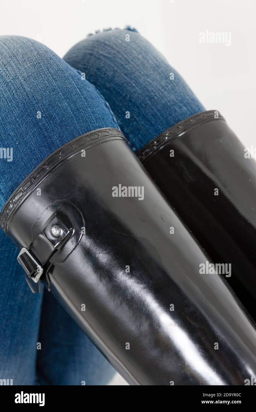 women's black rubber boots with blue jeans Stock Photo Alamy