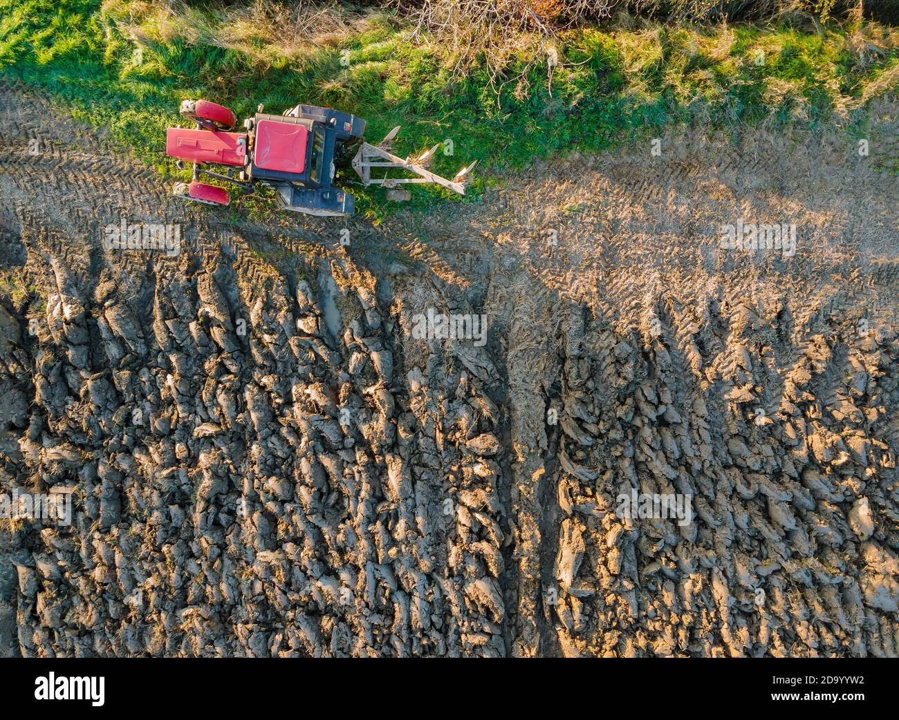 Tractor plowing fields preparing land for soil sowing grain Stock Photo