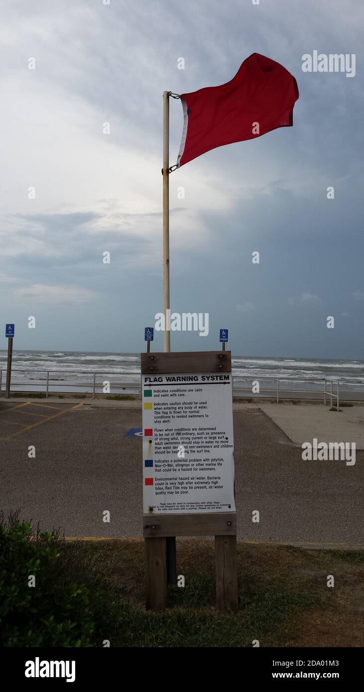 A red flag signals a high wind warning on a Gulf of Mexico beach Stock Photo