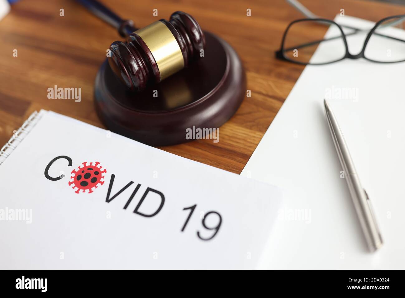 Judges gavel and legal documents lying on table in courthouse closeup Stock Photo