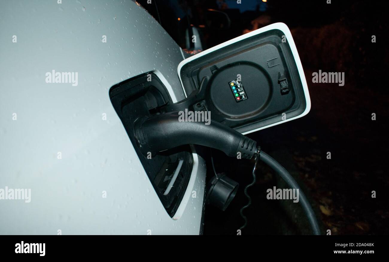 Electric Car Charger At Home Charging EV at Night With Wall Charger