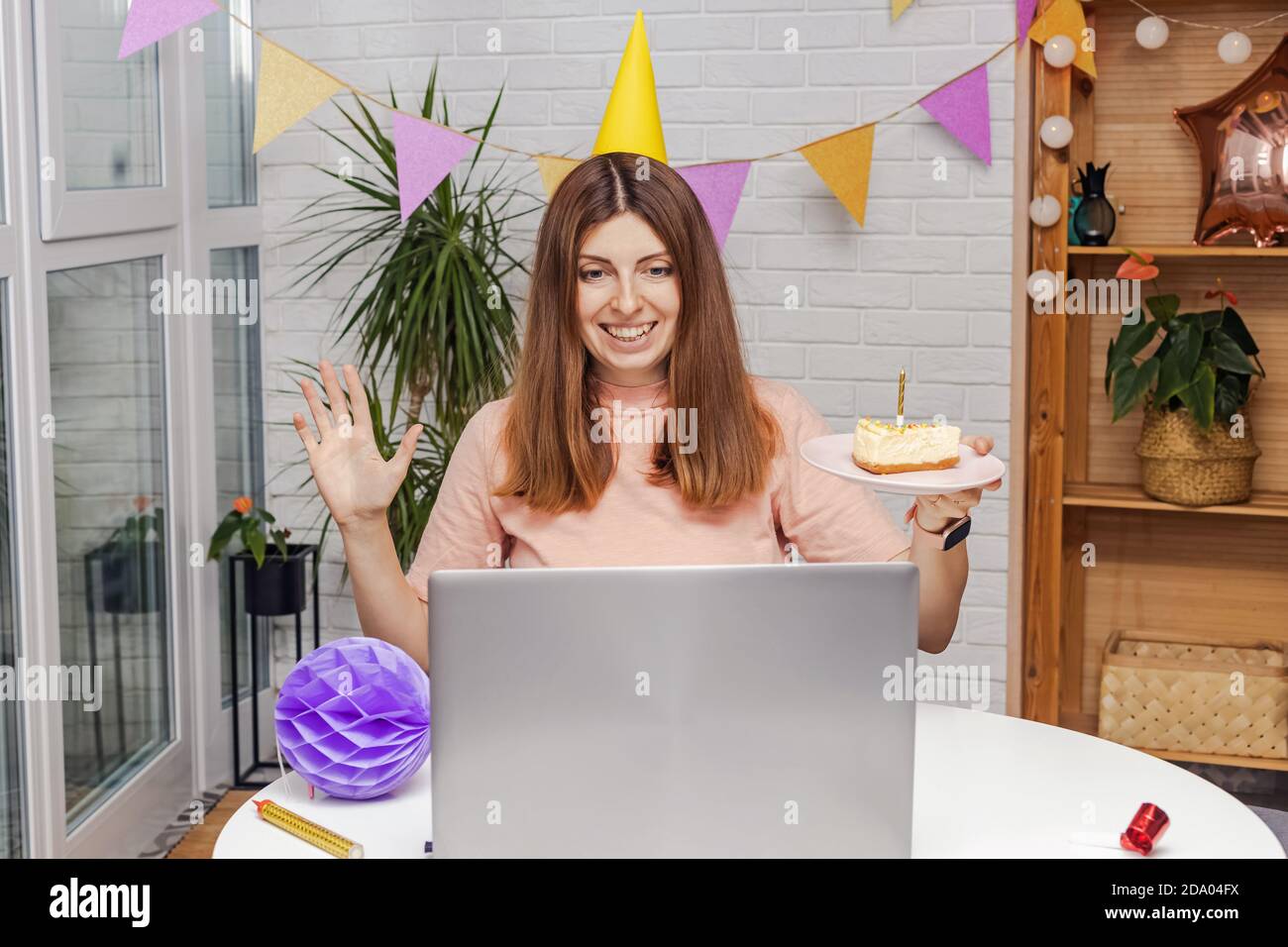 Woman celebrating birthday at home and communicate by video chat Stock Photo