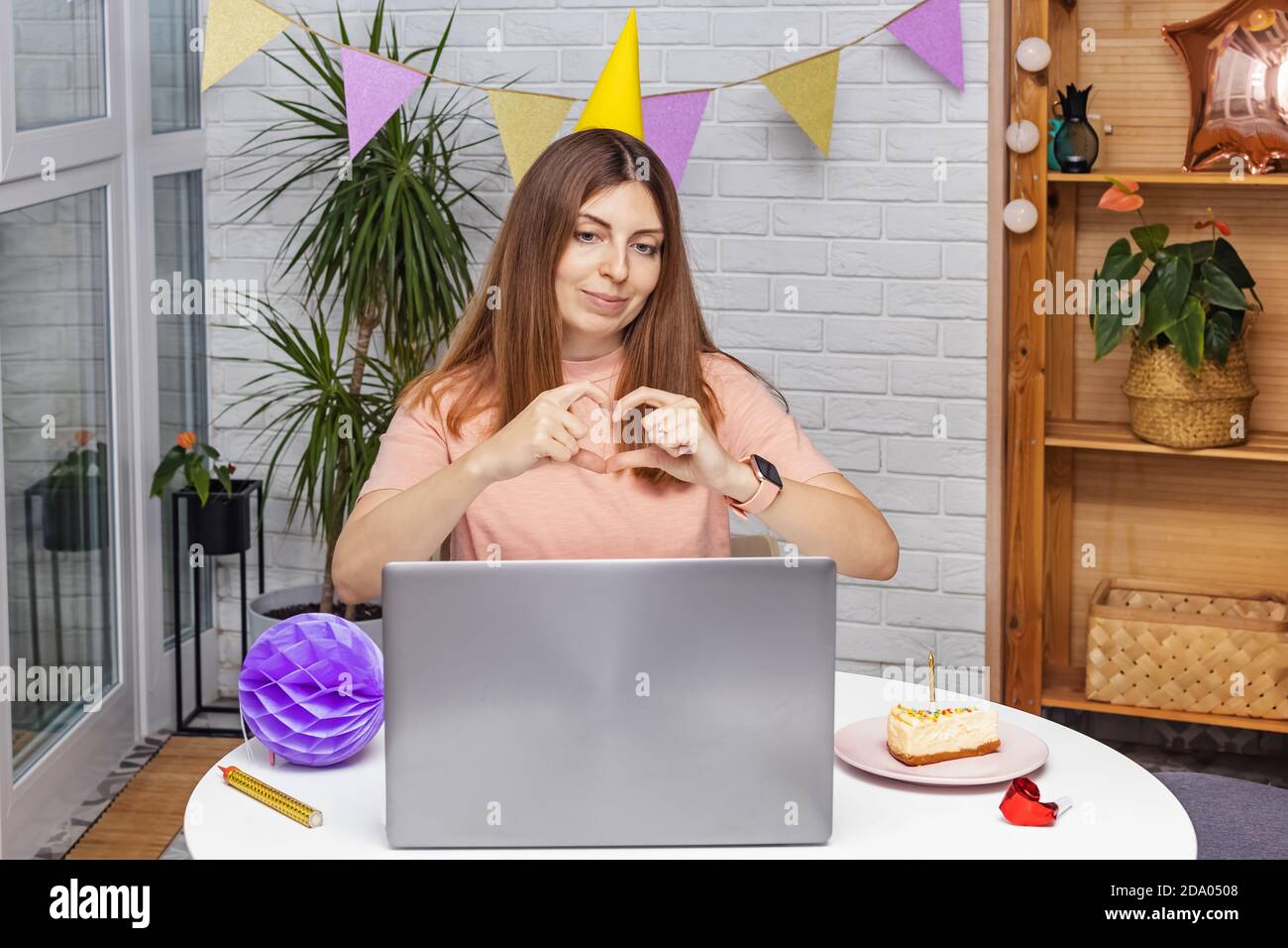 Woman celebrating birthday at home and communicate by video chat Stock Photo